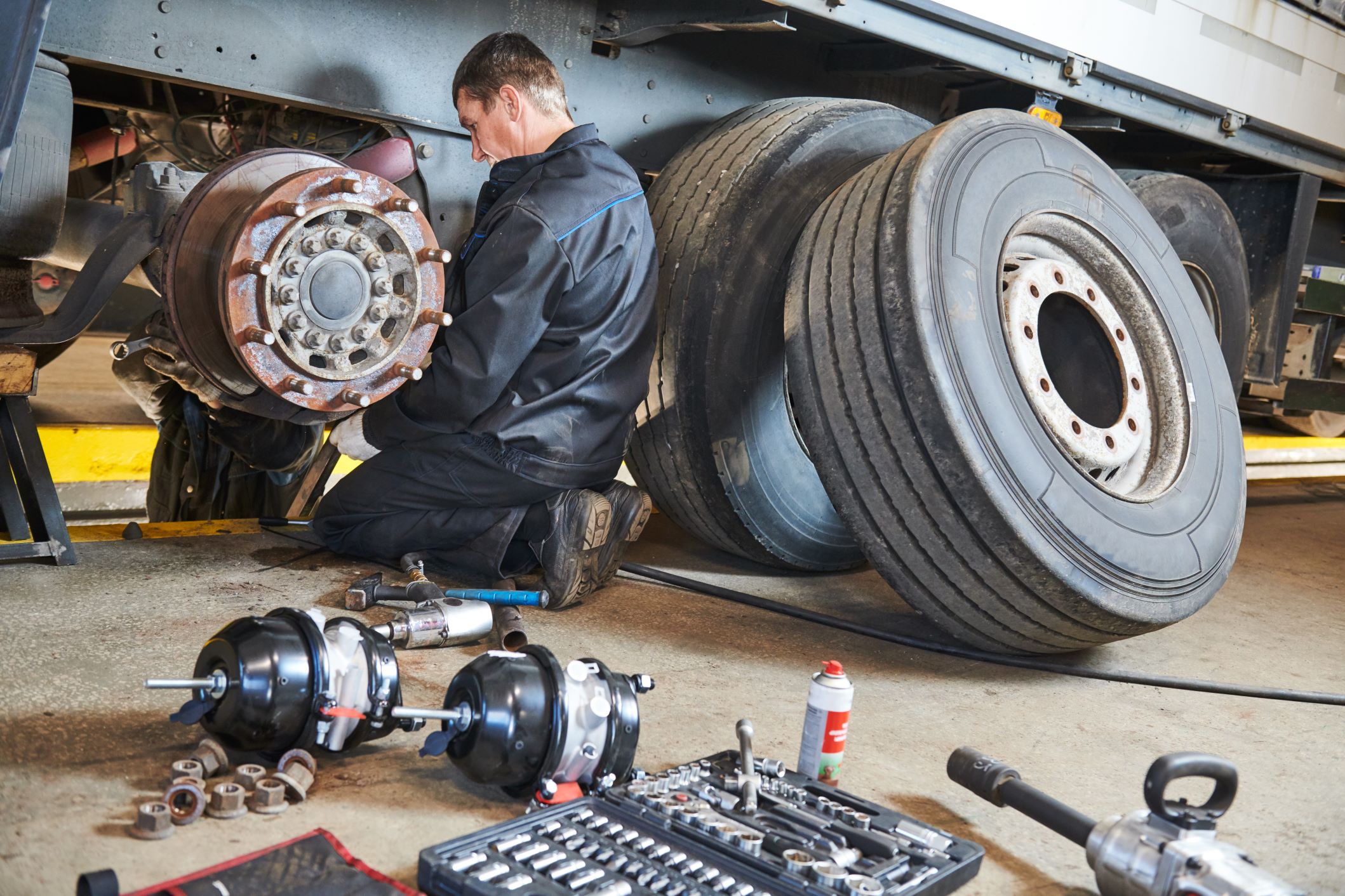 Mechanic working on tire rims and axle