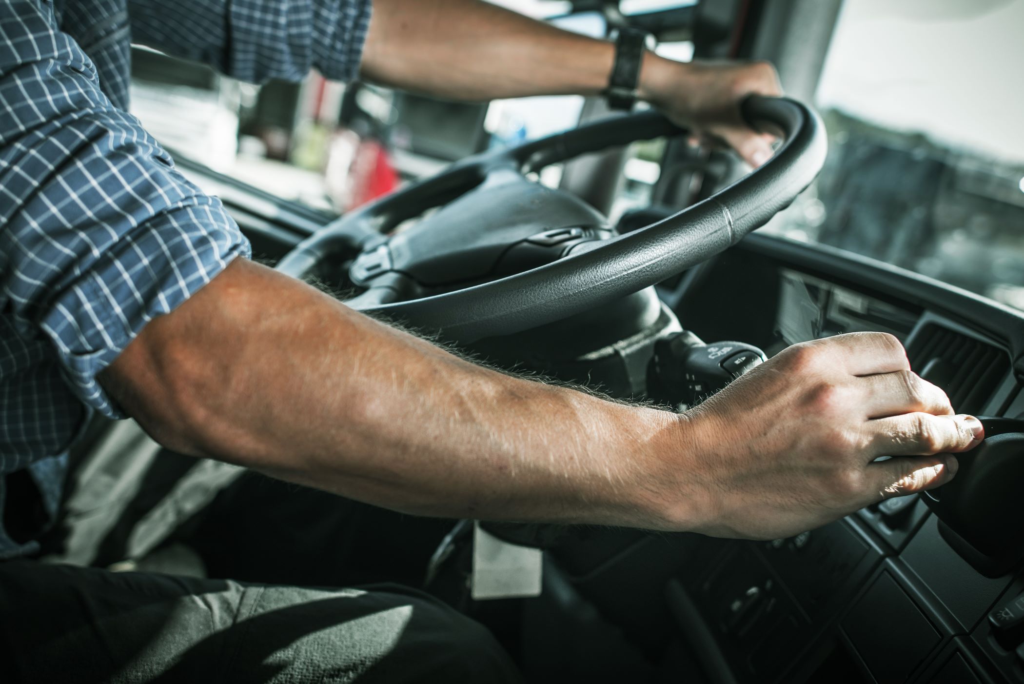 Truck driver operating inside the cabin