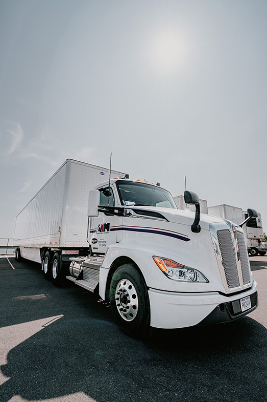 Image of Aim tractor trailer parked.
